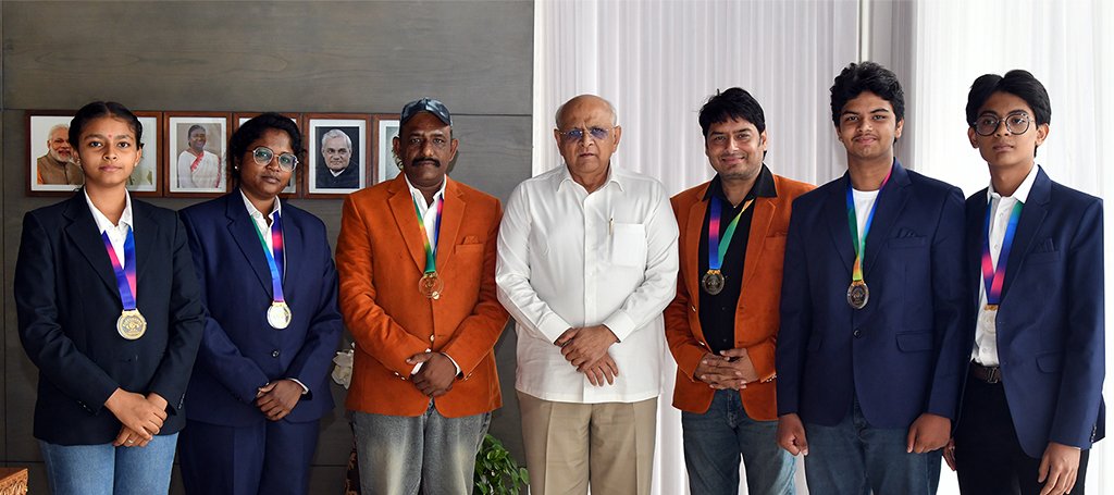 Gujarat martial arts team receiving national championship trophy award ceremony sports hall India ce